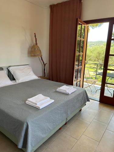 a bedroom with a bed with two towels on it at Beach Villa Pasithea in Neokhórion