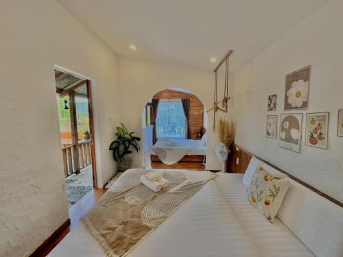 a bedroom with a large bed in a room at Cloudy Hillside Botique - Homestay in Ấp Ða Lợi
