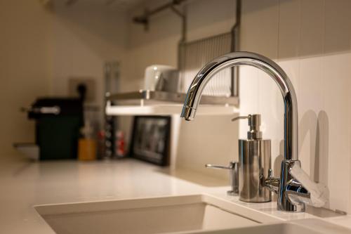 a kitchen sink with a faucet on a counter at Private Premium Apartment in Plovdiv in Plovdiv