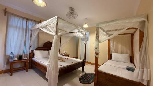 Кровать или кровати в номере Zanz Bay Hotel