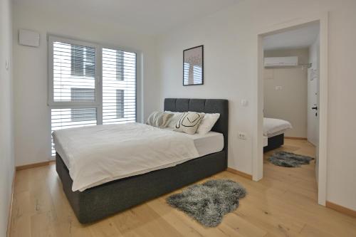 Postel nebo postele na pokoji v ubytování URBAN LODGE PREMIUM Apartments