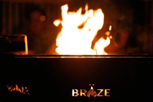 a fire in a fireplace with the words braize at Luxury Glamping Tali Pod Escape with Private HotTub in Pembroke
