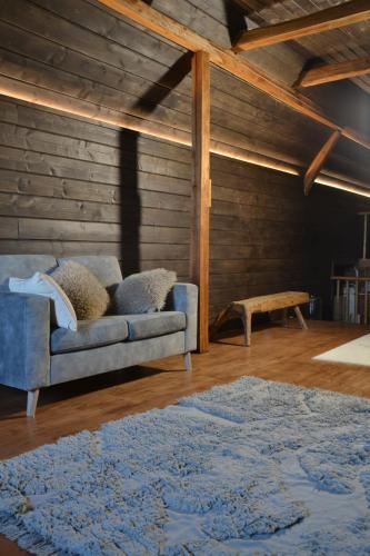 a living room with a couch and a table at Wallilan Yliset in Äänekoski