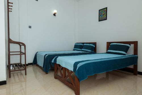 two beds sitting next to each other in a room at Ever Top Resort Kithulgala in Kitulgala