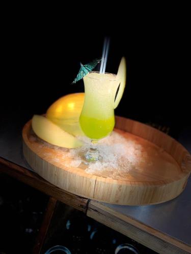 a drink sitting on a wooden tray with an umbrella at The City Hotel in Durham