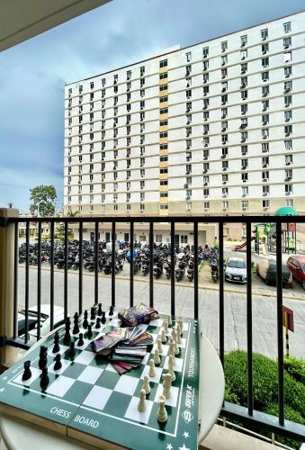 a chess board on a table in front of a building at Studio Retreat with Balcony and Pool in Suba