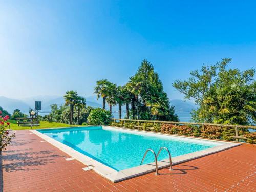 una piscina in un resort con palme di Residenza Verde Lago a Stresa