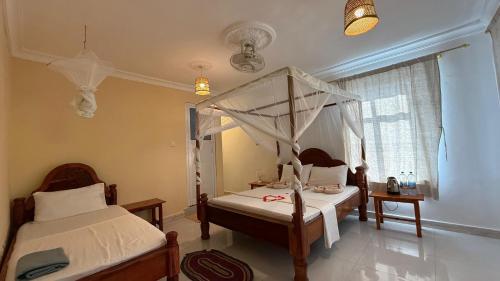 Кровать или кровати в номере Zanz Bay Hotel