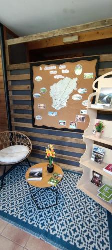 a room with a table and a map on the wall at Camping de Collonges-la-Rouge in Meyssac