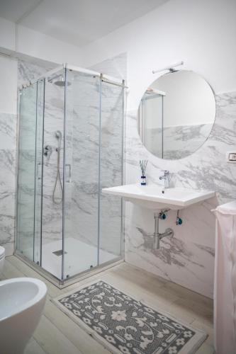 a bathroom with a shower and a sink and a mirror at Sunrise Place Casa Vacanze in Praia a Mare