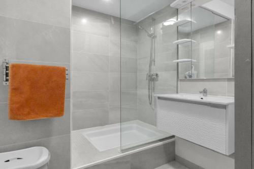 a bathroom with a shower sink and a toilet at Marigot Bay in Saint Martin