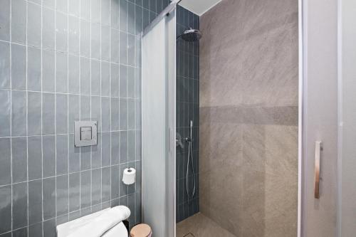 a bathroom with a shower and a toilet at Artemis 202 - Seaside Stories in Livadhia