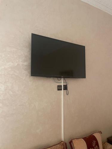 a flat screen tv hanging on a wall at Riad Nour Resorts-Riad Nour Travel in Marrakech