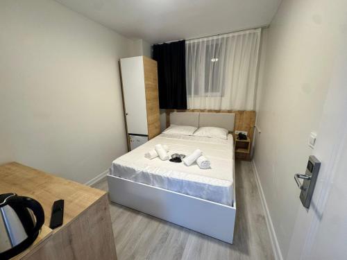 a small bedroom with a bed with towels on it at QLİNE HOTEL AİRPORT SaW in Istanbul