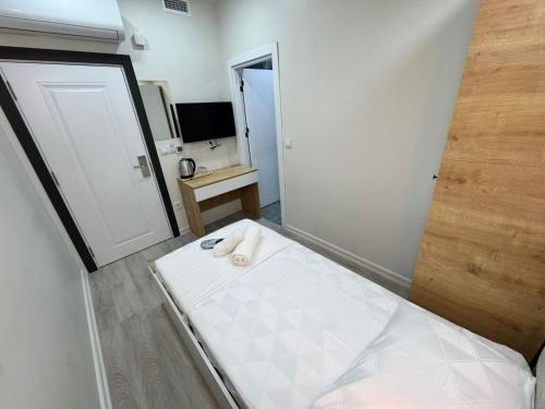 a small room with a bed and a mirror at QLİNE HOTEL AİRPORT SaW in Istanbul