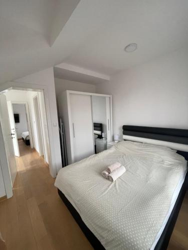 a bedroom with a bed with a towel on it at Stojicic ROYAL in Vrnjačka Banja