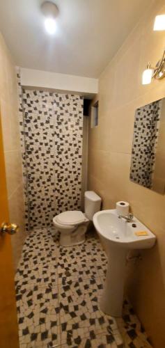 a bathroom with a toilet and a sink at Departamento jaspe in Cajamarca