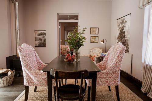 a dining room with a table and chairs at Dorp Hotel in Cape Town