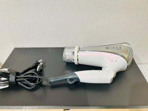a hair dryer sitting on top of a table at Etoile Kagurazaka-Queen Room near Shinjuku, Self Check-in in Tokyo