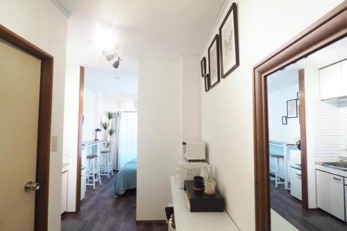 a hallway with a room with a bed and a mirror at Etoile Kagurazaka-Queen Room near Shinjuku, Self Check-in in Tokyo