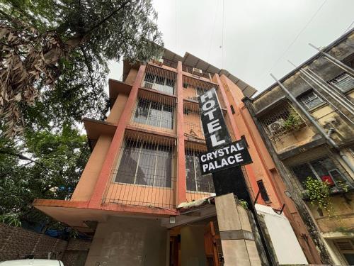 a building with a sign on the side of it at Hotel Crystal Palace in Jāmb