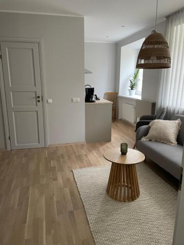 a living room with a couch and a table at Pikk 10 City Apartment, free parking in Pärnu