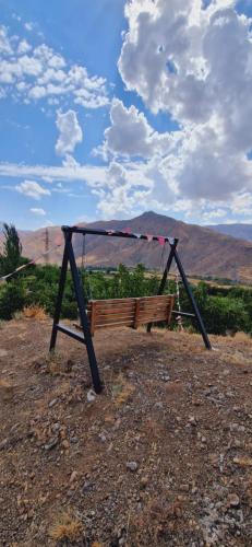 a swing set sitting on top of a field at GreenField Resort in Yeghegnadzor