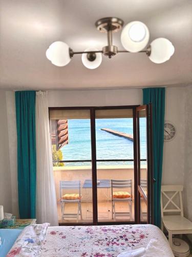 a bedroom with a bed and a view of the ocean at Apartments Sea Sunrise, complex Carpe Diem, FREE PARKING in Balchik