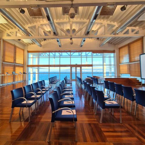 a conference room with blue chairs and a podium at Towers Hotel Stabiae Sorrento Coast in Castellammare di Stabia