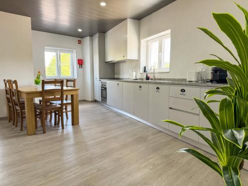 a kitchen with a table and a dining room at Flôr do Távora in Vila da Ponte