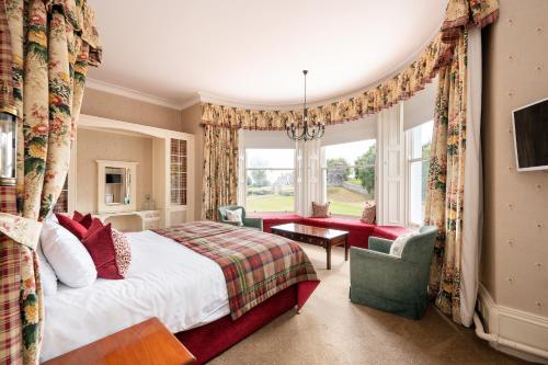 a bedroom with a bed and a large window at The Open Arms Hotel in Dirleton