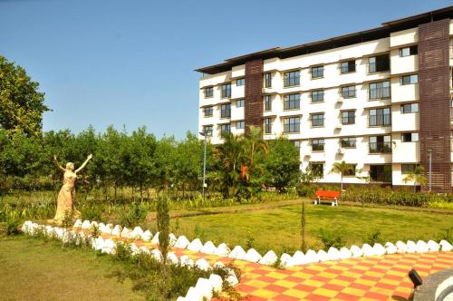 a statue of a statue of a woman in front of a building at Horizon Grande Apartments - Tarkarli in Malvan