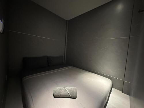 a small room with a bed with a towel on it at Havona Hotel - CIQ Johor Bahru - Self Check-In in Johor Bahru