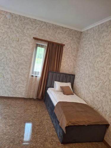 a bedroom with a bed and a window in it at Tatev Hotel in Tatʼev