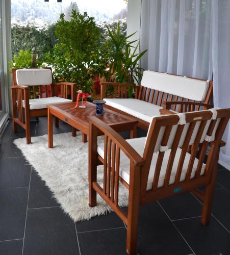 a wooden table and two chairs on a patio at Haus Bruegge in Mellau