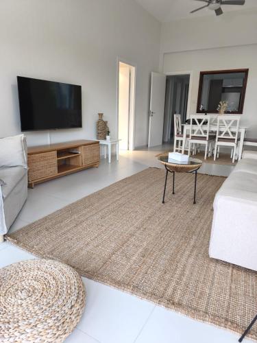 a living room with a tv and a couch at Stay and Nest Casa Nola Elegant Modern Bungalow, Pool & Sea Location, Paphos in Chlorakas