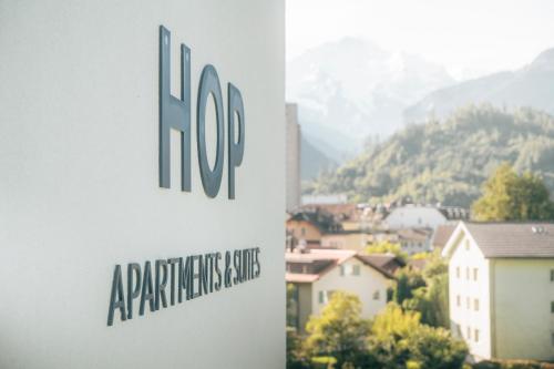 a sign for a building with a view of a city at HOP Apartments & Suites in Interlaken
