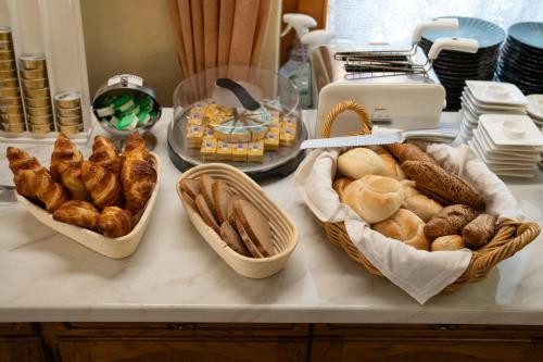 three baskets of bread and pastries on a counter at Haus Kärnten in Döbriach