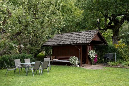 a gazebo with a table and chairs in a yard at Haus Kärnten in Döbriach