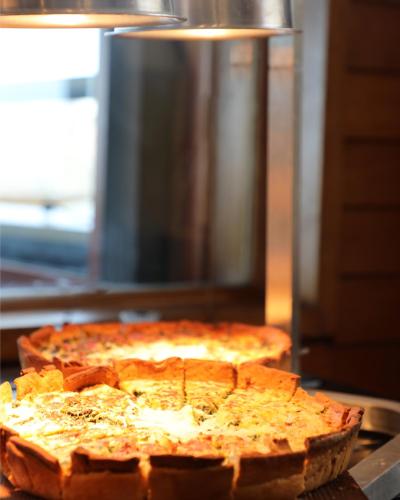 two pizzas sitting on top of a table at Monteverde Hotel in Beit Meri