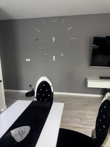a living room with a clock on the wall at Apartament Quick Check In in Tomaszów Mazowiecki