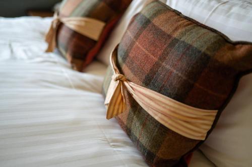 two pillows sitting on top of a bed at The Open Arms Hotel in Dirleton