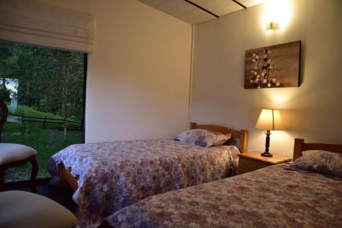 a hotel room with two beds and a window at Condominio Hacienda Shangrila in San Francisco