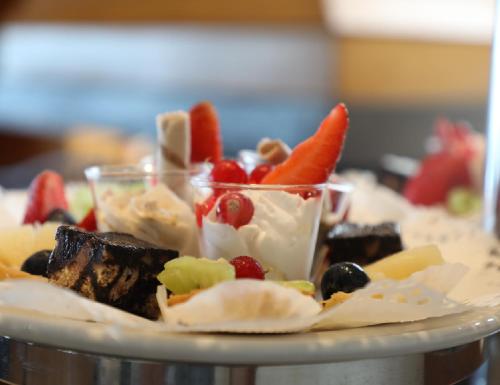 a plate of food with fruit and other foods at Monteverde Hotel in Beit Meri