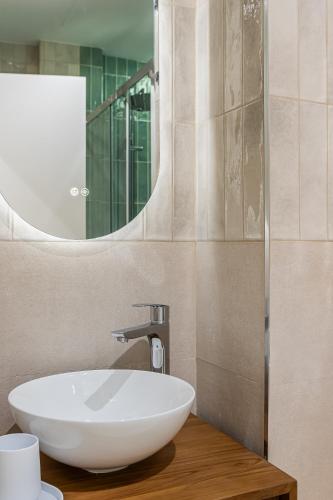 a bathroom with a white sink and a mirror at Queens Bernabéu in Madrid