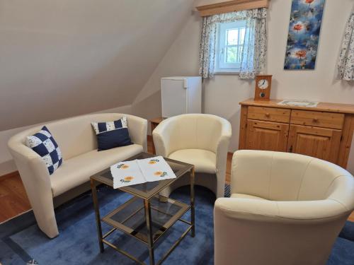 a living room with two chairs and a couch and a table at Ferienhaus Gertrud in Sankt Stefan ob Stainz