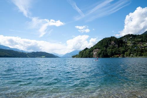 a person in a boat on a large lake at Haus Kärnten in Döbriach