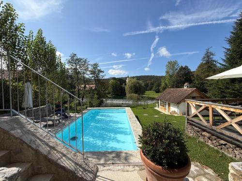 a swimming pool in a yard with a house at PAVI APARTMENTS River Estate Krka in Krka