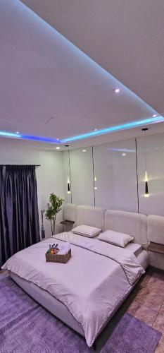 a large white bed in a room with a large white bedvisor at Winters Apartments in Abuja