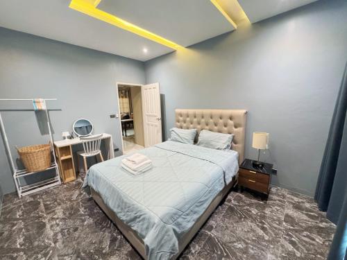 a bedroom with a bed and a desk and a mirror at Jmpoolvilla in Nakhon Si Thammarat